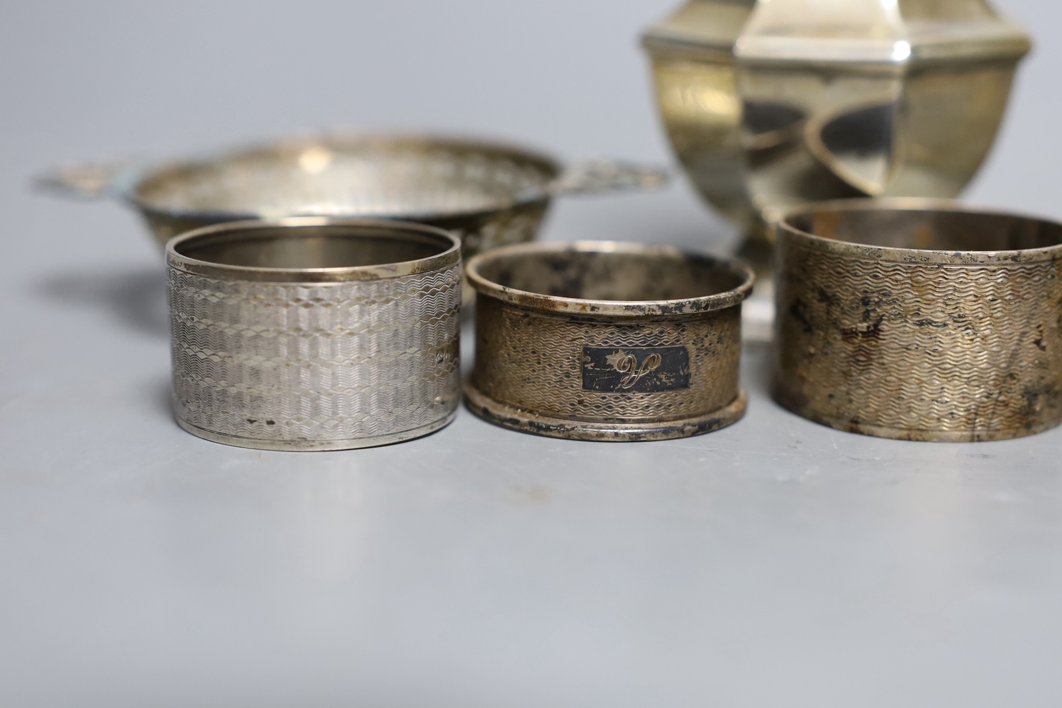 A George V silver sugar caster, London, 1933, 17cm, a silver topped glass toilet jar, a silver bon bon dish and five silver serviette rings.